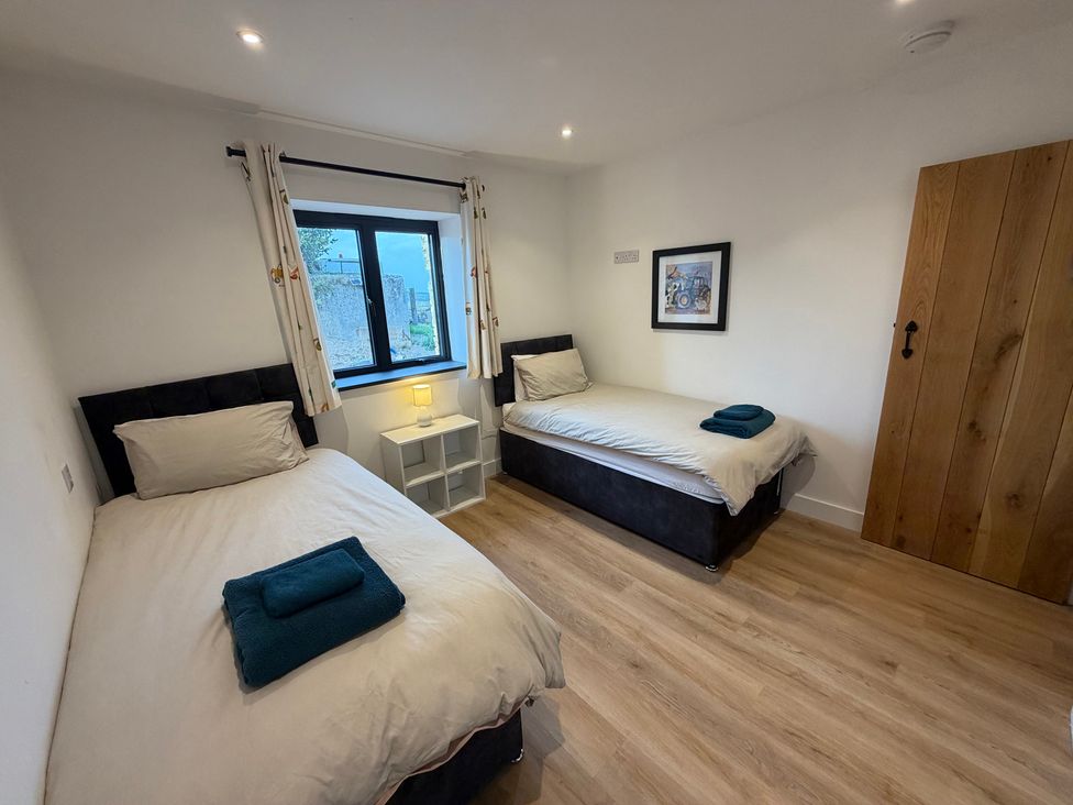 A bedroom with two beds and a window at High View Barn Launceston