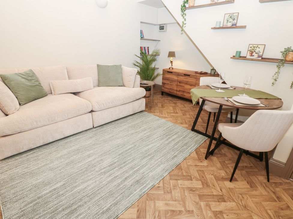 A living room with a sofa and dining area at Corner House in Wark