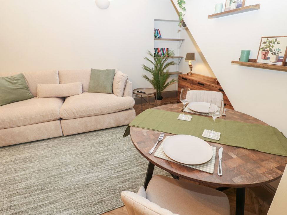 A living room with a dining area and sofa at Corner House Wark