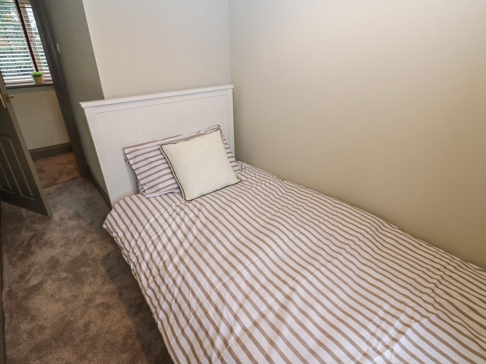 A bedroom with a single bed and a pillow at Corner House in Wark