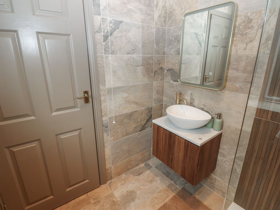 A bathroom with a sink and mirror at Corner House in Wark