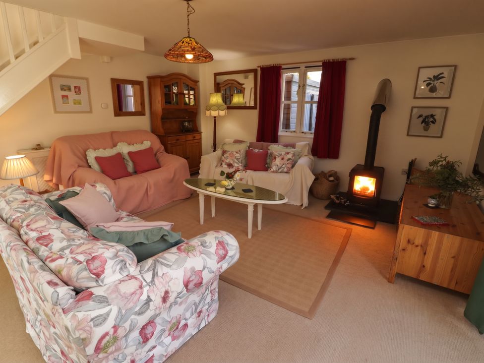 A living room with sofas and a stove at 11b Market Street in Narberth