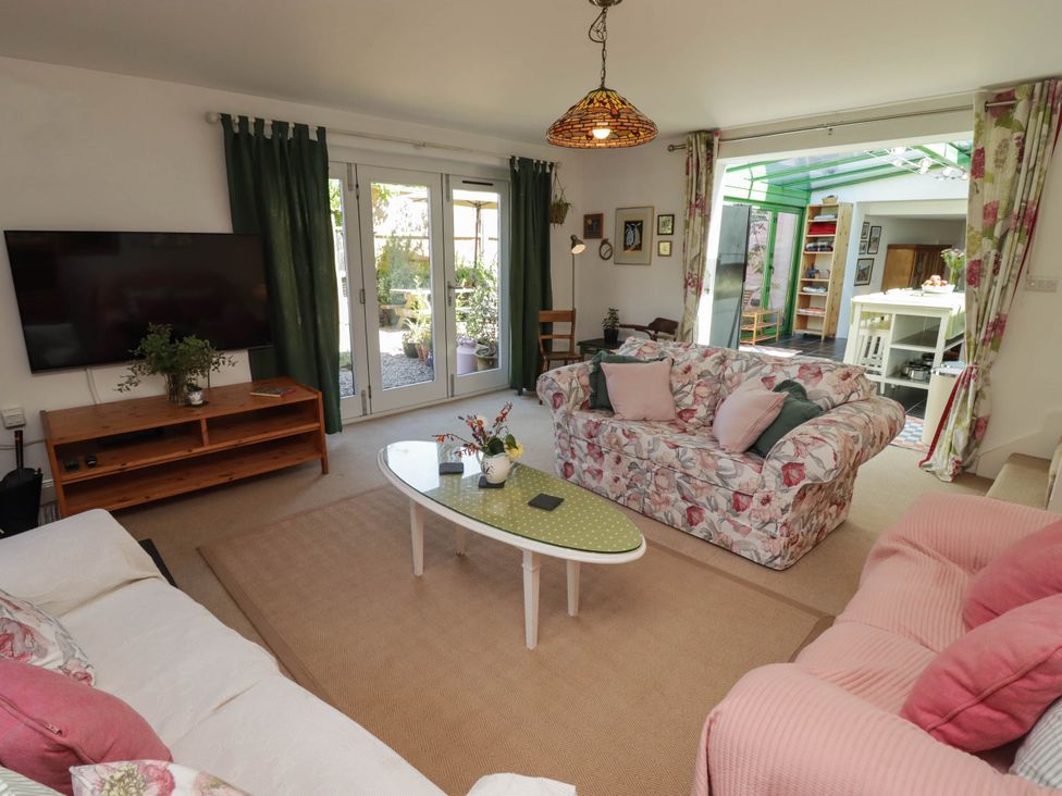 A living room with a television and sofa at 11b Market Street in Narberth