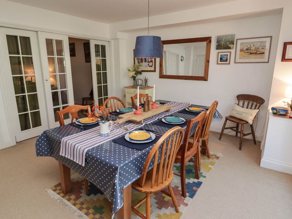 A dining room with a table set for meals at 11b Market Street Narberth