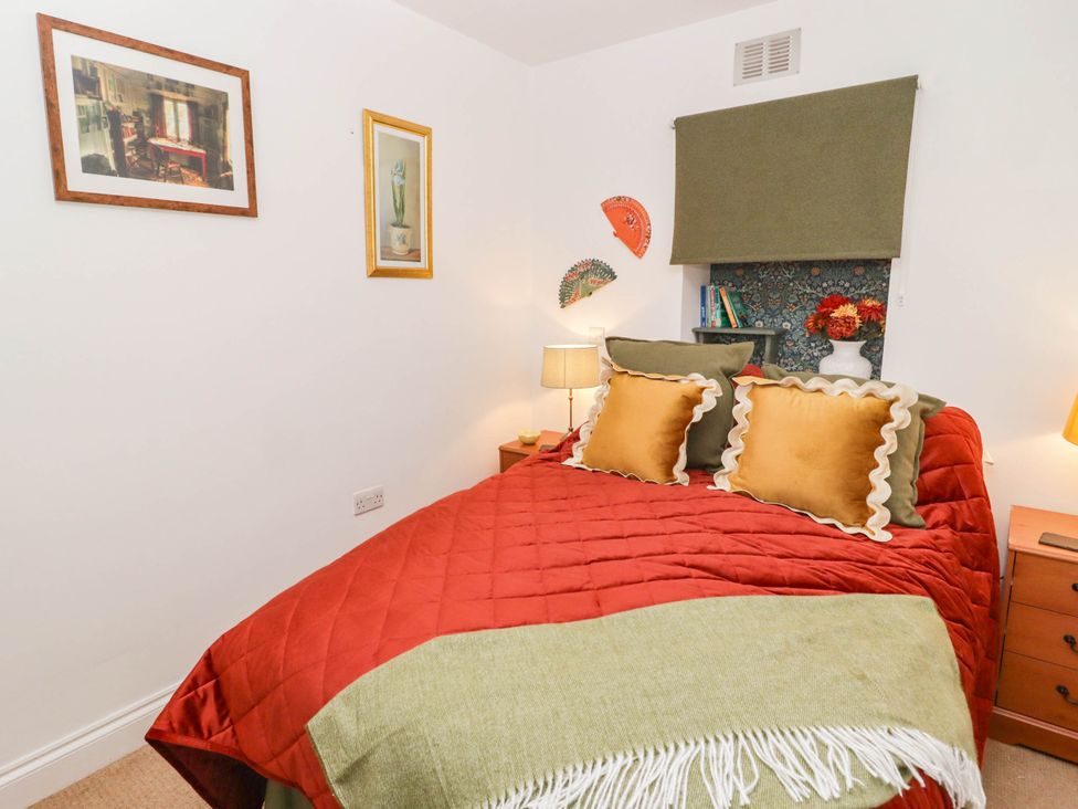 A bedroom with a bed and bedside tables at 11b Market Street Narberth