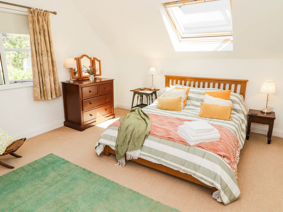 A bedroom with a bed and dresser at 11b Market Street in Narberth