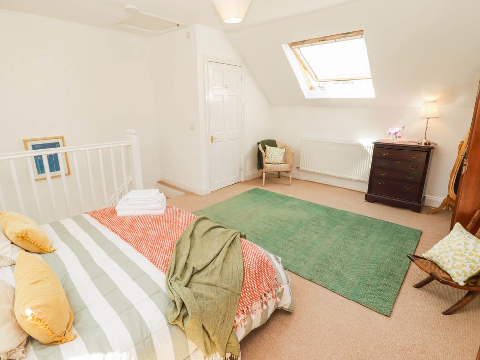 A bedroom with a bed and dresser at 11b Market Street Narberth
