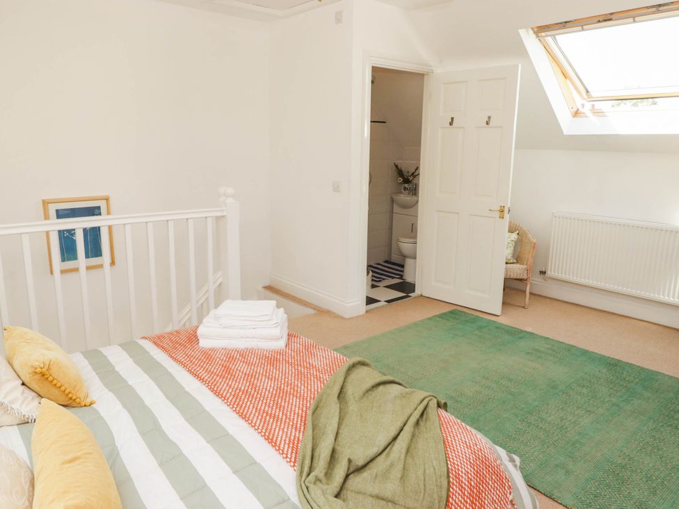 A bedroom with a bed and an ensuite bathroom at 11b Market Street in Narberth