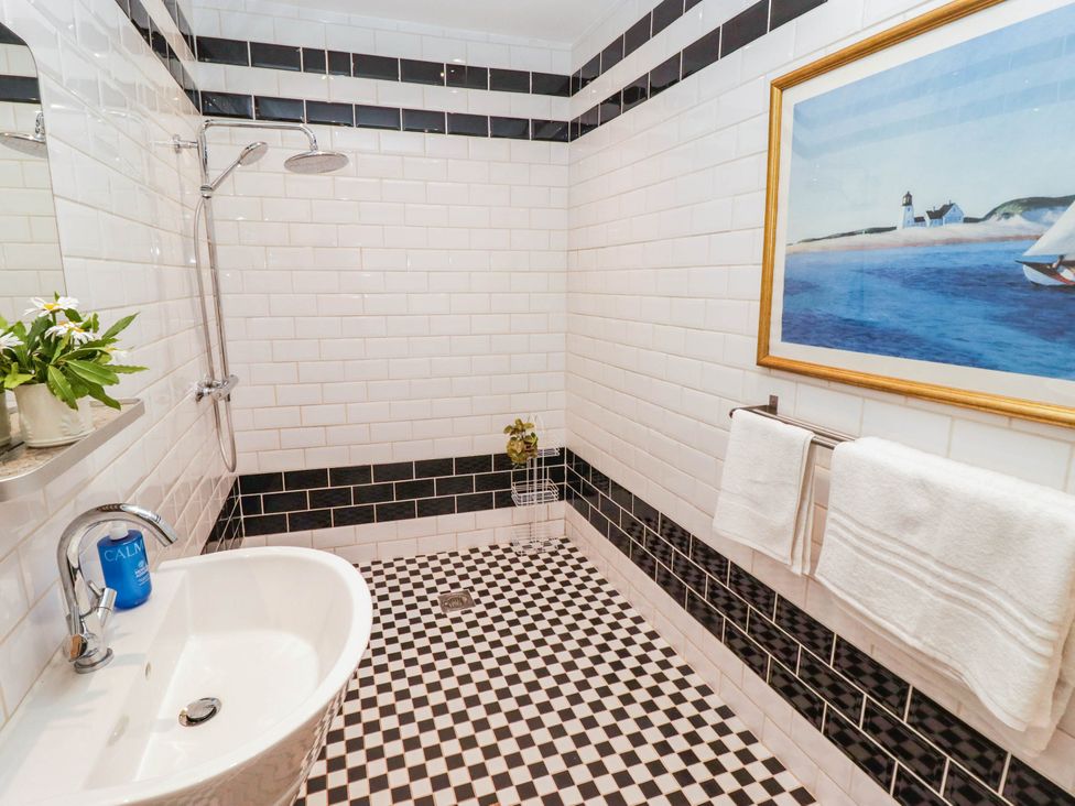 A bathroom with a shower and tub at 11b Market Street in Narberth