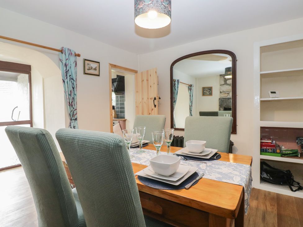 A dining room with a table set for meals at Bluebell Cottage Heysham