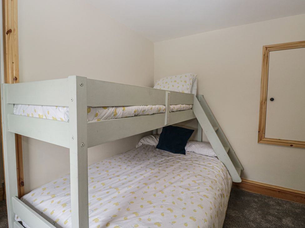 A bedroom with a bunk bed and mattress at Bluebell Cottage in Heysham