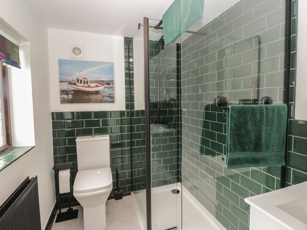 A bathroom with a shower and toilet at Bluebell Cottage in Heysham