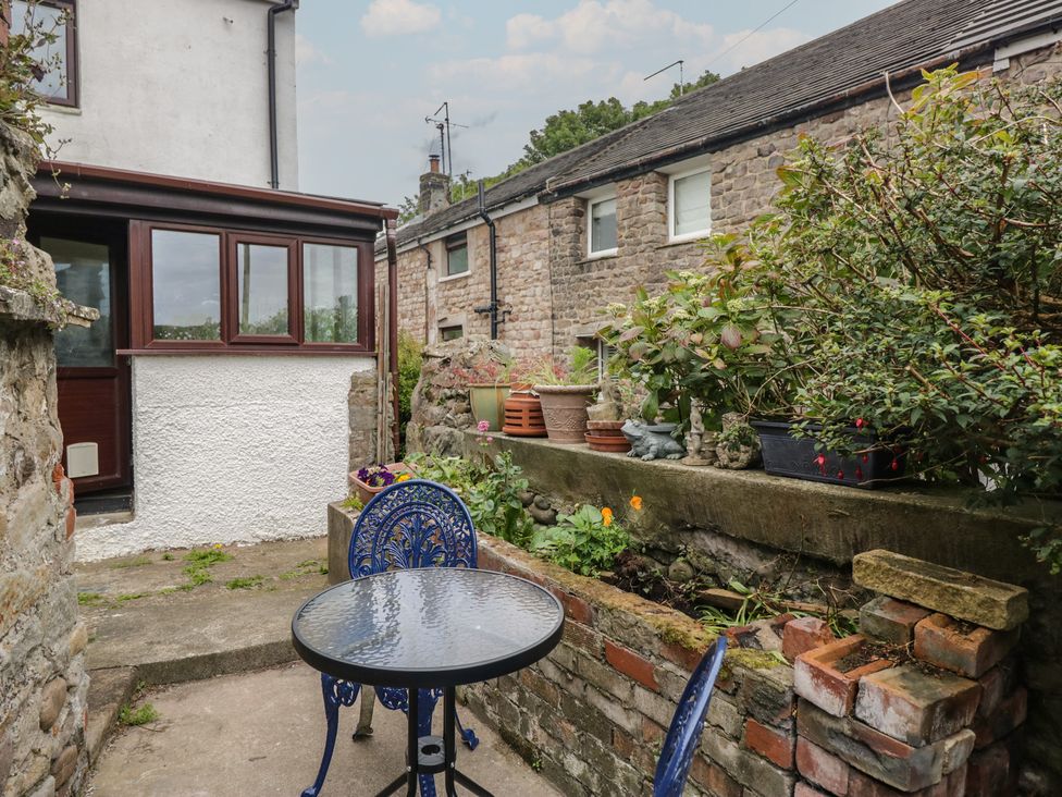 A garden with a table and chairs at Bluebell Cottage in Heysham