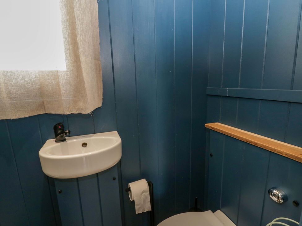 A bathroom with a sink and toilet at The Hut in Llandysul