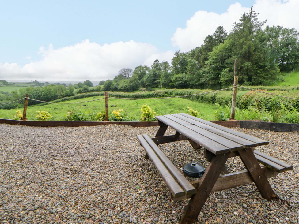 A picnic table in a garden at The Hut in Llandysul