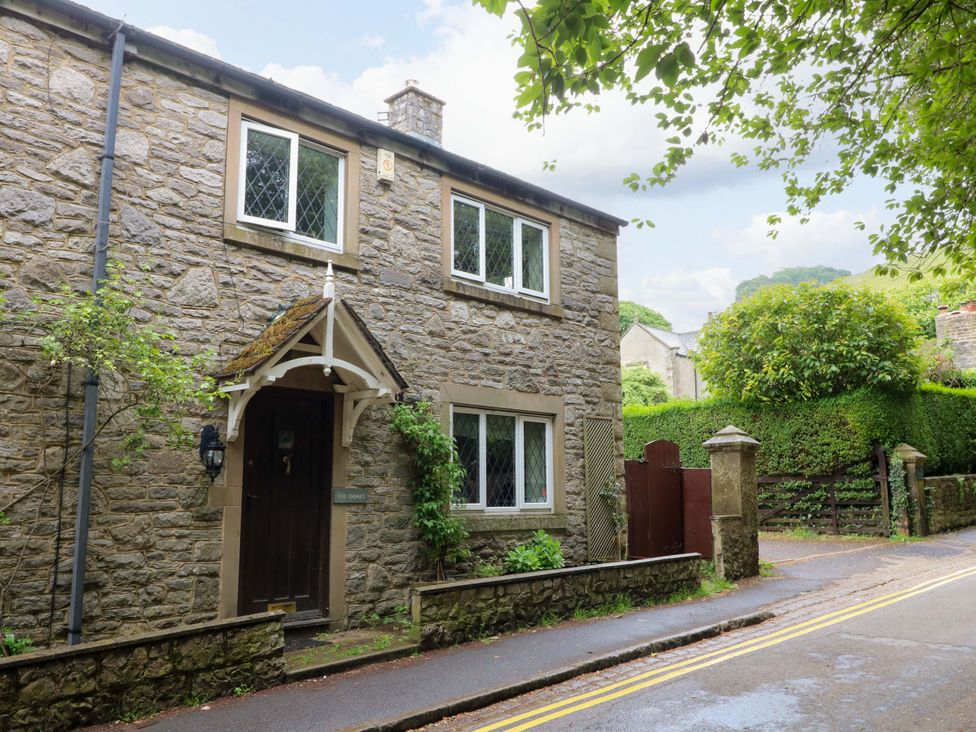 A stone house with windows and a door at The Chimes in Hope Valley