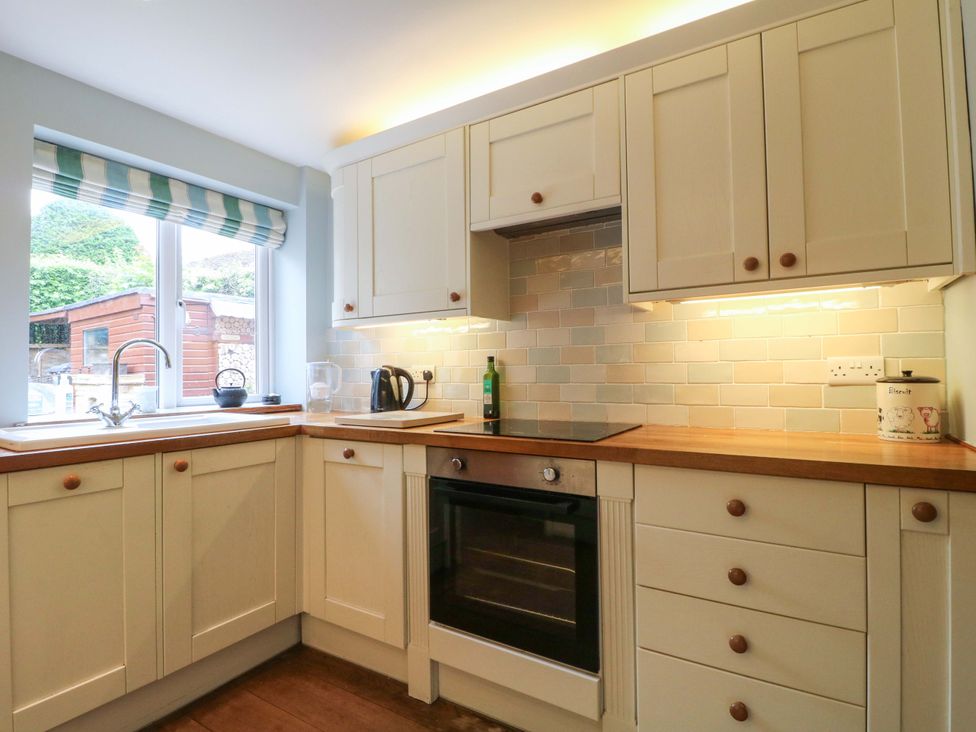 A kitchen with cabinets and stove at The Chimes in Hope Valley