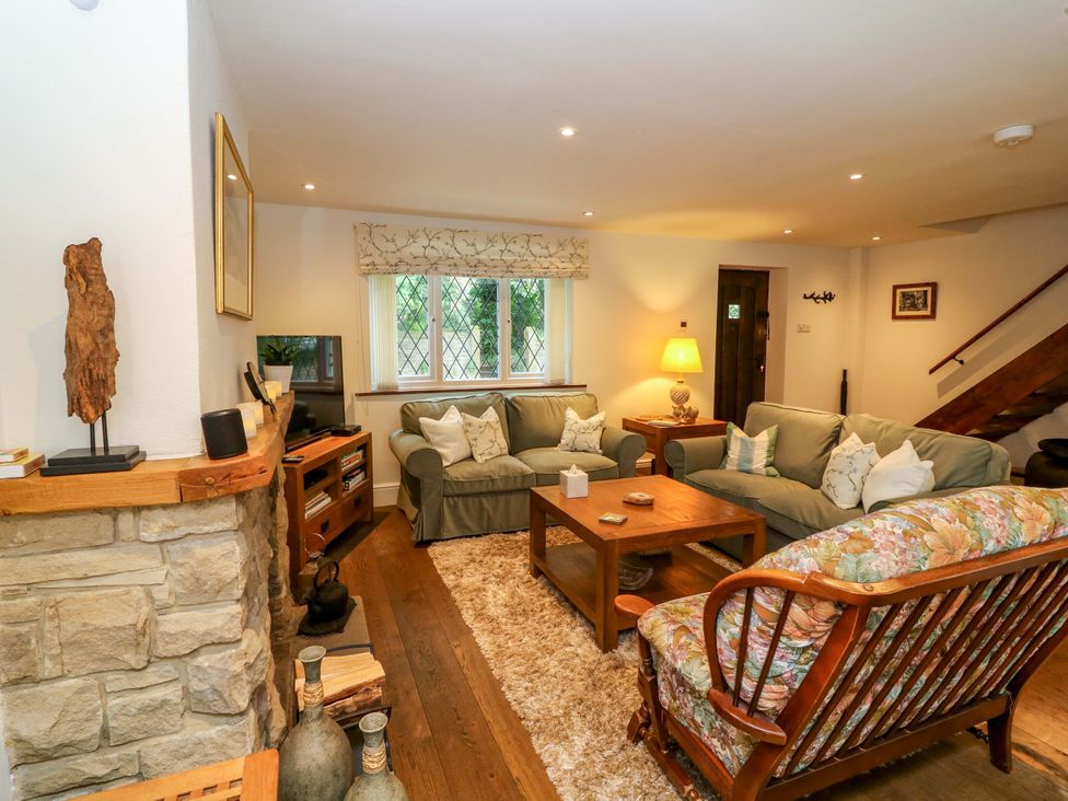 A living room with a sofa and coffee table at The Chimes in Castleton, Peak District