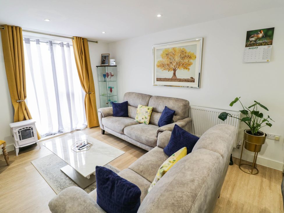 A living room with sofas and a coffee table at 4 Goldcrest Close in Daventry
