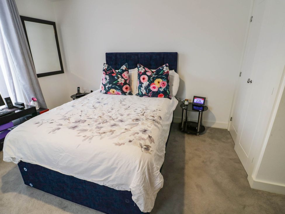A bedroom with a bed and bedside table at 4 Goldcrest Close in Daventry