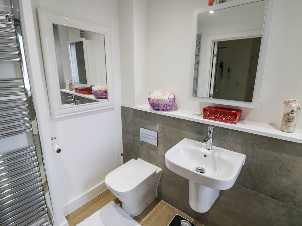 A bathroom with a toilet and sink at 4 Goldcrest Close Daventry
