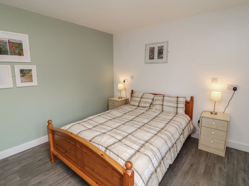 A bedroom with a bed and nightstands at Catley, Billinghay, Lincolnshire