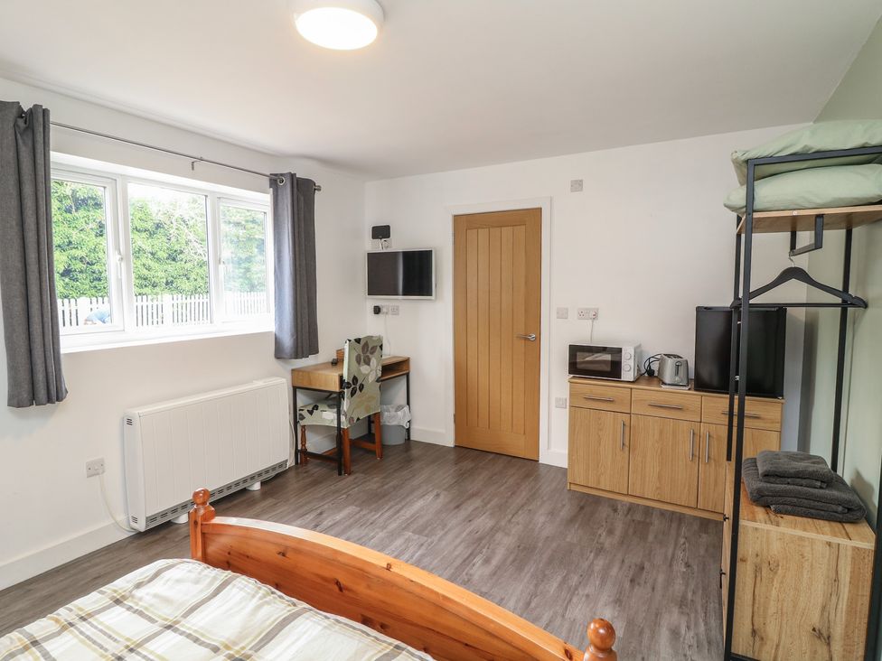 A bedroom with a bed and desk at Catley, Billinghay, Lincolnshire