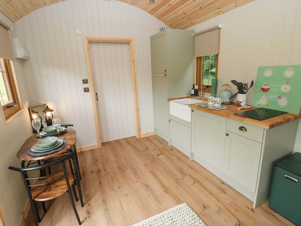 A kitchen with a sink and stove in Shepherd Hut 2
