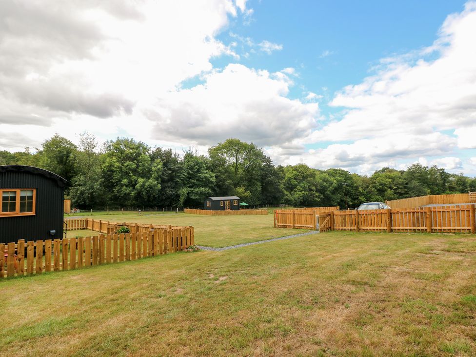 An outdoor area with cabins and a vehicle at Cwtch Y Bugail 2 Near Llandeilo