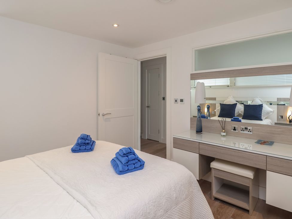 A bedroom with a bed and towels on it at 5 Sails in Dartmouth