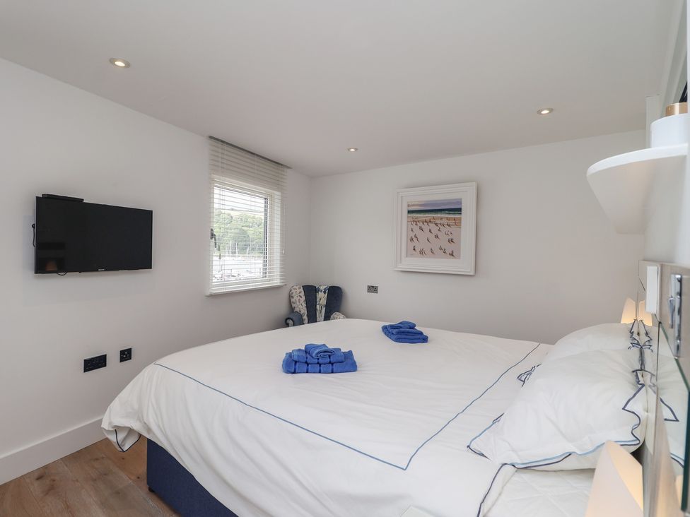 A bedroom with a bed and a television at 5 Sails in Dartmouth