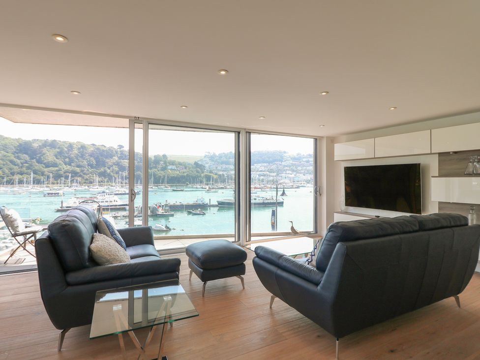 A living room with a view of the harbor at 5 Sails in Dartmouth
