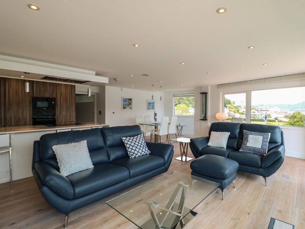 A living room with couches and a dining area at 5 Sails in Dartmouth