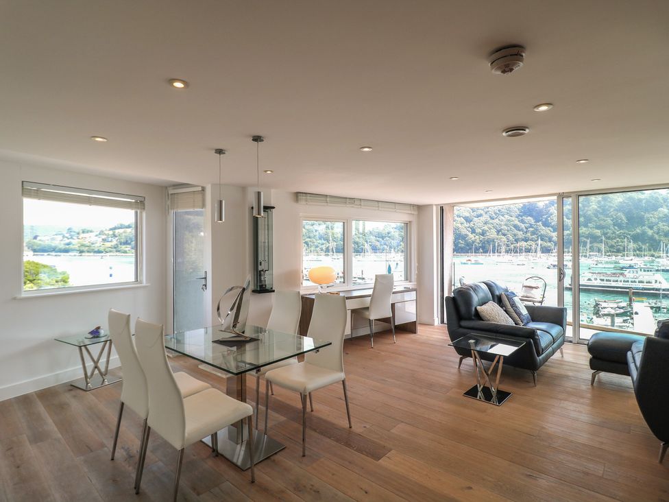 A living room with a table and chairs at 5 Sails in Dartmouth