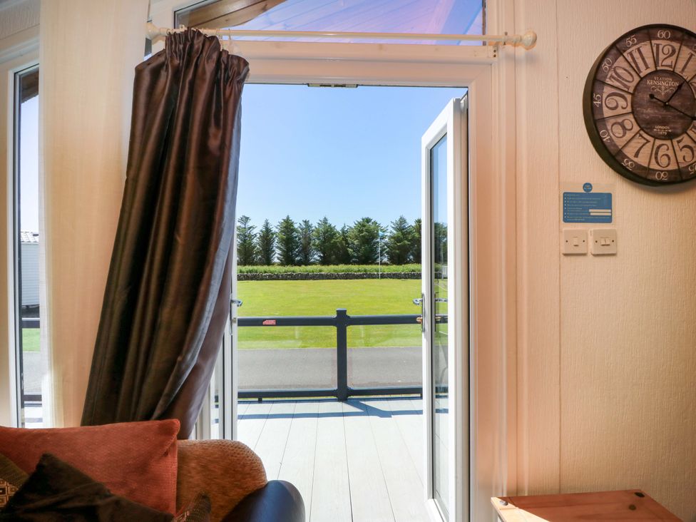 A living room with an open door and a view outside at Queensway QW1, Dumfries