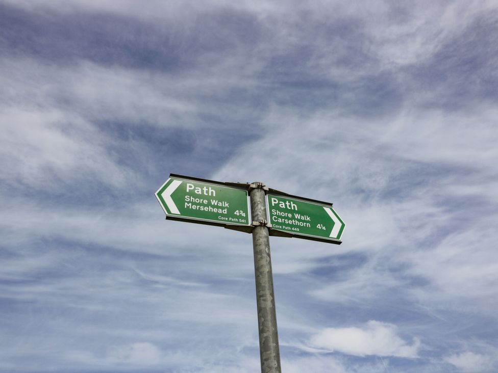 A signpost indicating paths to Mersehead and Carsethorn