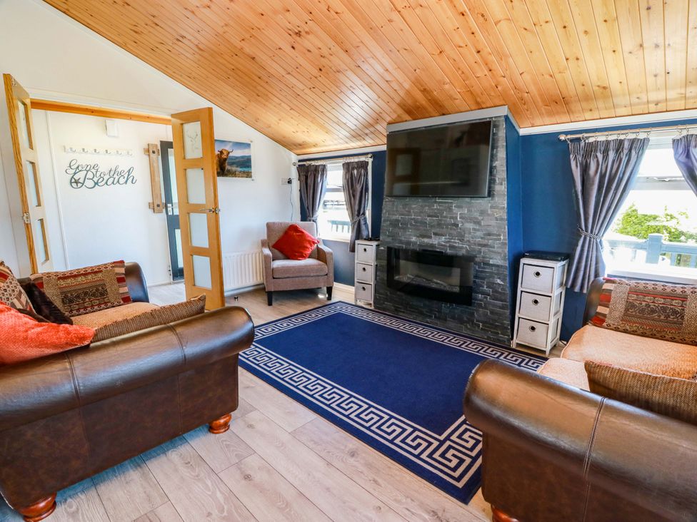 A living room with a fireplace and television at Queensway QW1 Dumfries