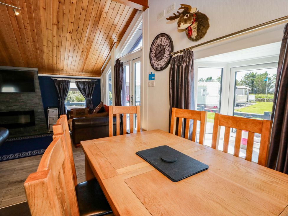 A dining area with a table and chairs at Queensway QW1 Dumfries