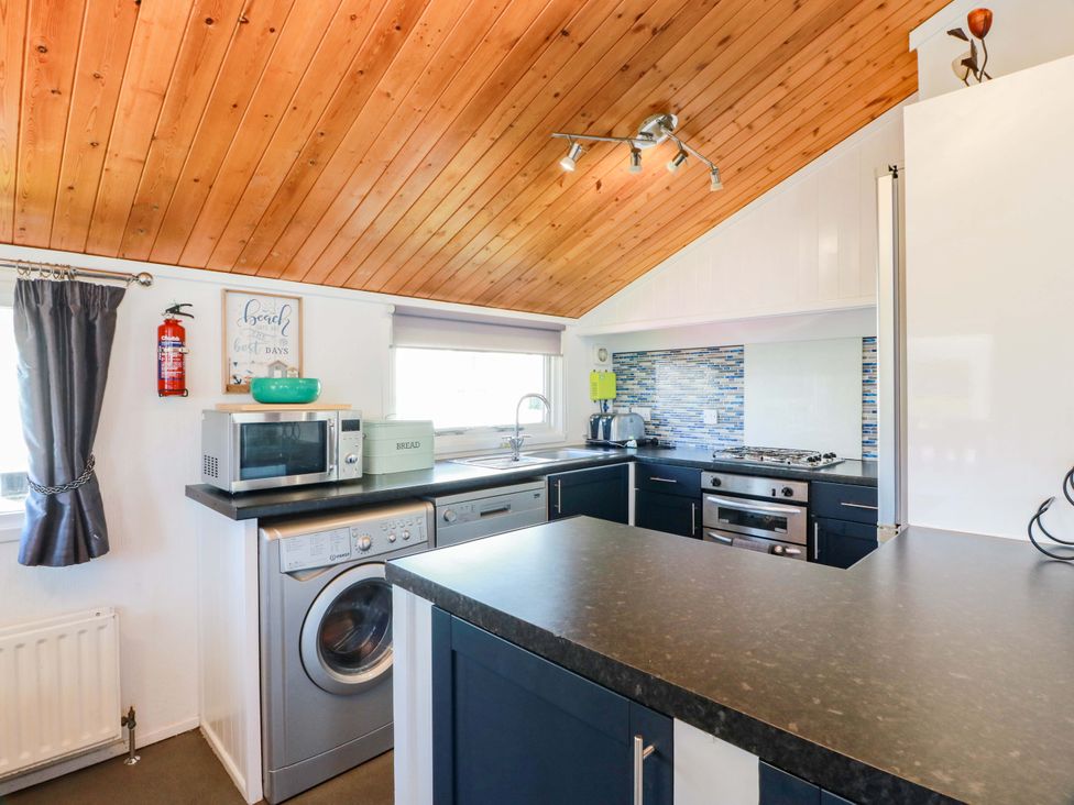 A kitchen with appliances and a wooden ceiling at Queensway QW1 in Dumfries