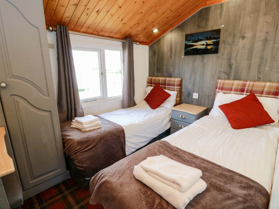 A bedroom with two single beds and a nightstand at Queensway QW1 in Dumfries