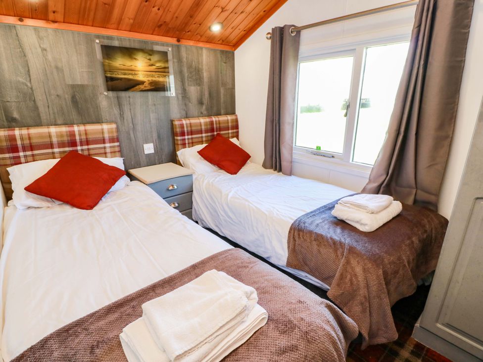 A bedroom with two single beds and a window at Queensway QW1 Dumfries