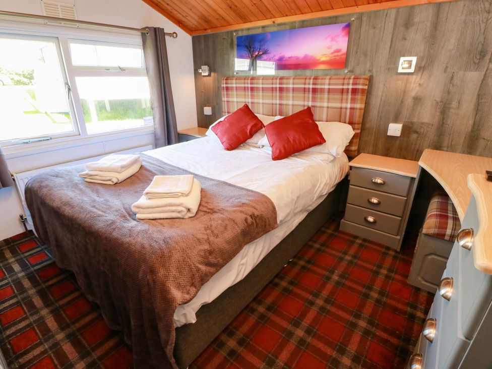 A bedroom with a double bed and nightstand at Queensway QW1 Dumfries