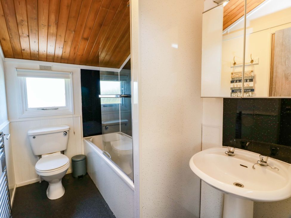 A bathroom with a bathtub and sink at Queensway QW1 Dumfries