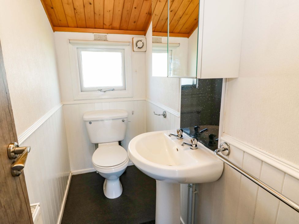 A bathroom with a toilet and sink at Queensway QW1 in Dumfries