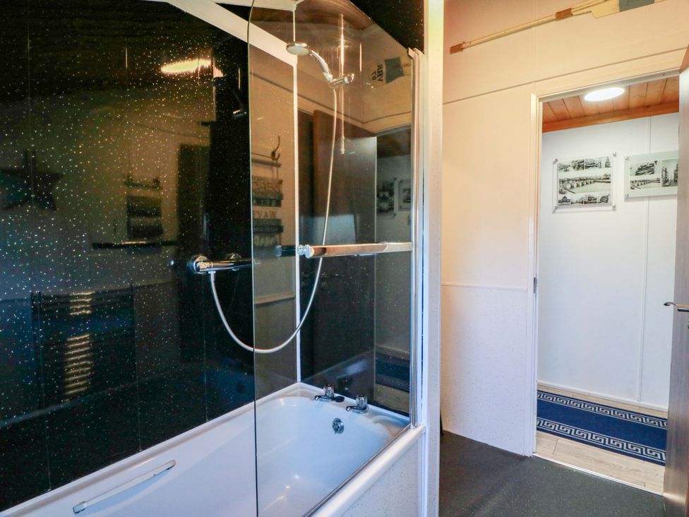 A bathroom with a shower and bathtub at Queensway QW1 in Dumfries