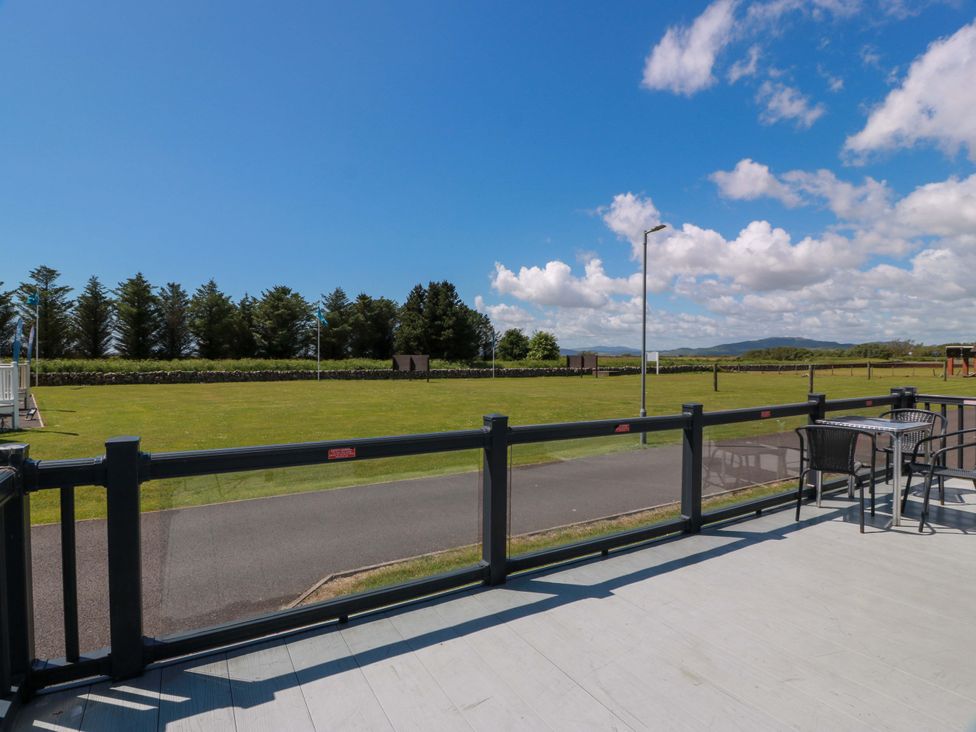 An outdoor area with a table and chairs overlooking a field at Queensway QW1 Dumfries
