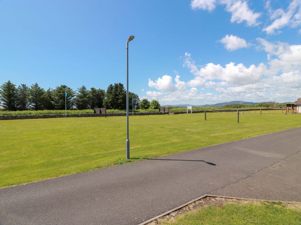 An outdoor area with grass, trees, and a lamp post at Queensway QW1, Dumfries