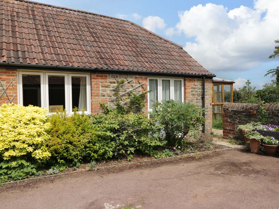 An exterior view of a house with plants and a garden at The Garden Studio in Bremhill near Calne