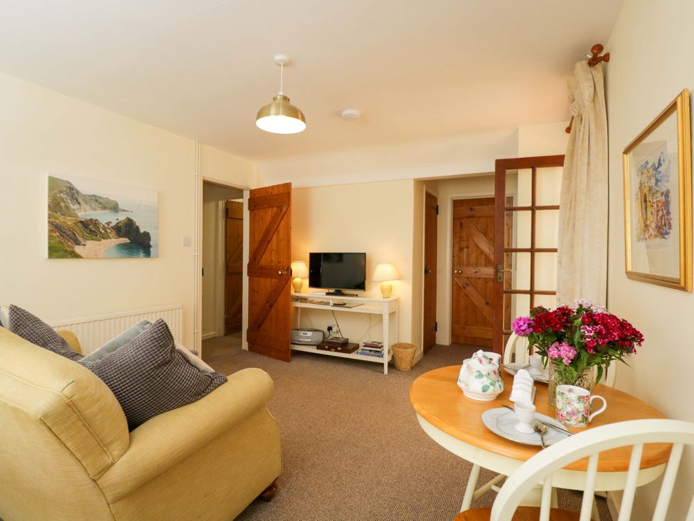 A living room with a sofa and table at The Garden Studio in Bremhill near Calne