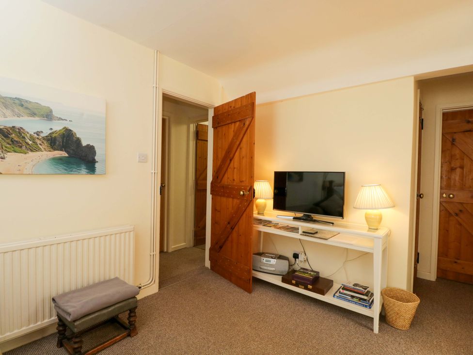 A living room with a television and seating at The Garden Studio in Bremhill near Calne
